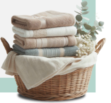 Folded towels in a wicker laundry basket