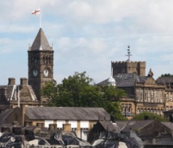Stone town buildings, rooftops and a clock tower